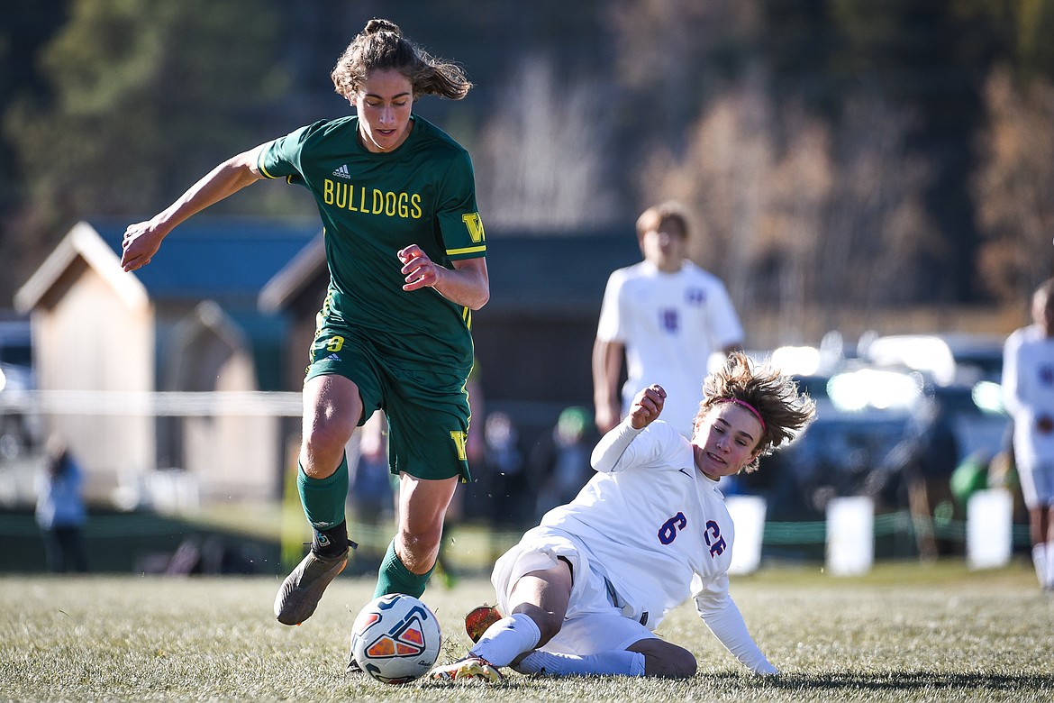 Whitefish's Gabe Menicke (9) pushes the ball upfield against Columbia Falls' Dale Blickhan (6) during the Class A boys soccer championship at Smith Fields in Whitefish on Saturday. (Casey Kreider/Daily Inter Lake)