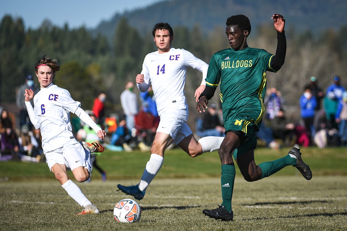 Whitefish's Marvin Kimera (22) pushes the ball into the Columbia Falls zone in the first half of the Class A boys soccer championship at Smith Fields in Whitefish on Saturday. (Casey Kreider/Daily Inter Lake)