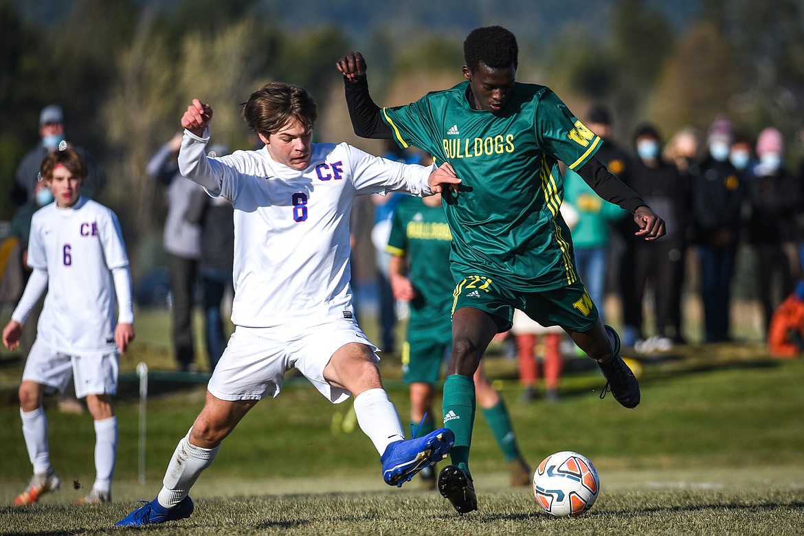 Whitefish's Marvin Kimera (22) looks to shoot with Columbia Falls' Nico Lang (8) defending during the first half of the Class A boys soccer championship at Smith Fields in Whitefish on Saturday. (Casey Kreider/Daily Inter Lake)