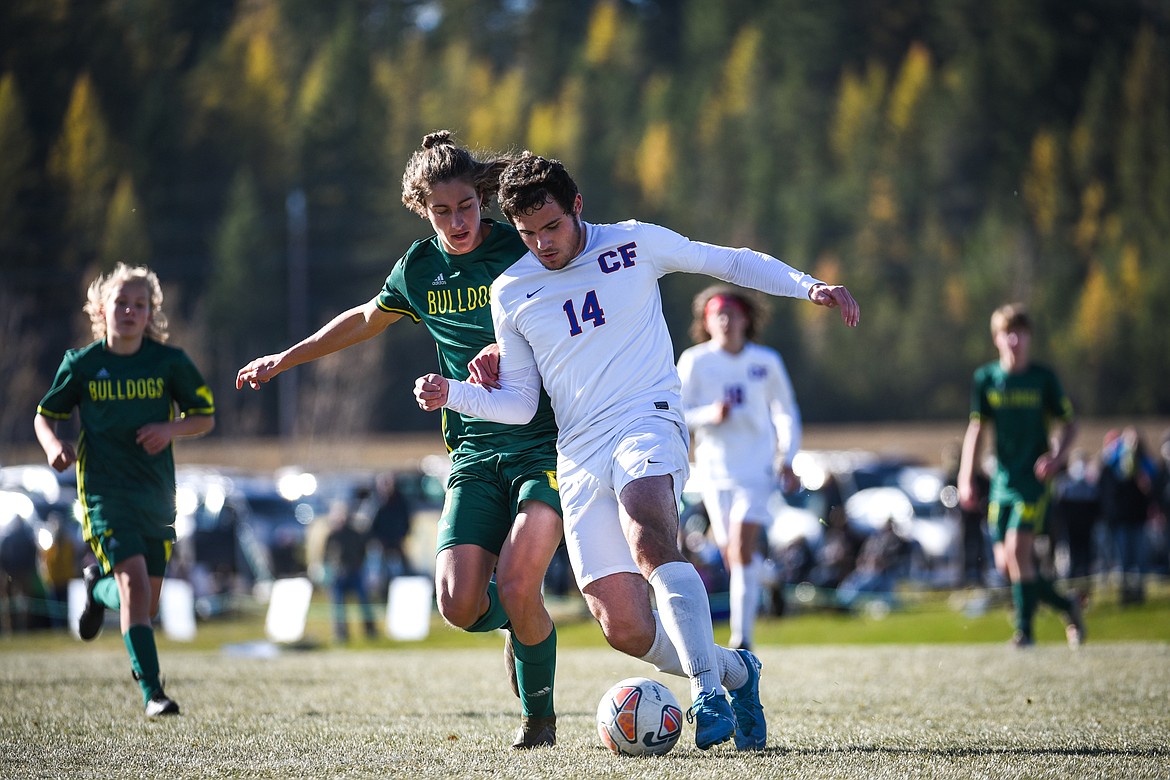 Whitefish's Gabe Menicke (9) and Columbia Falls' Tyler Hull (14) battle for a ball in the second half of the Class A boys soccer championship at Smith Fields in Whitefish on Saturday. (Casey Kreider/Daily Inter Lake)