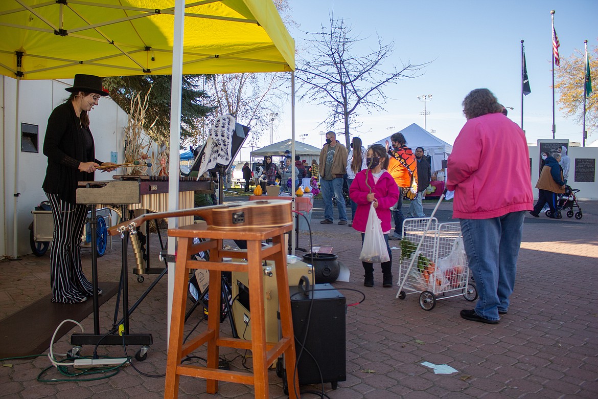 Alysen Hesselroth, left, performs Halloween songs at the Farmers Market in Moses Lake on Saturday.