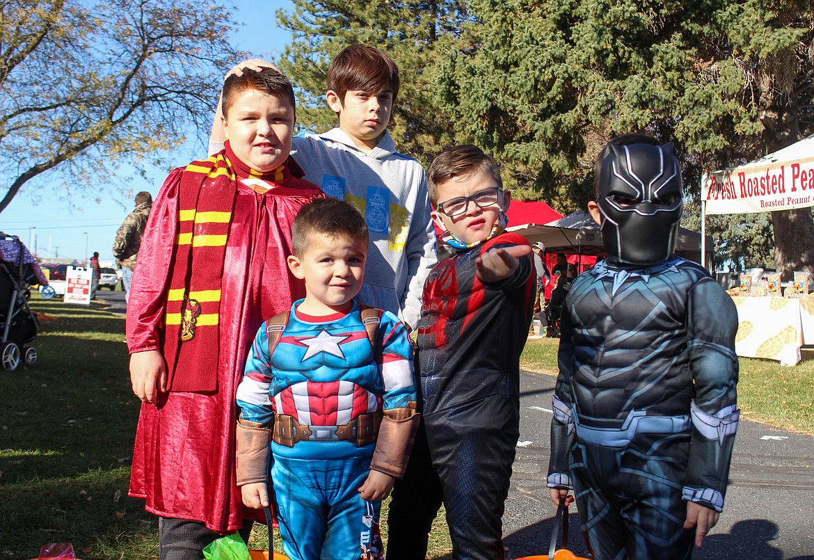 Left to right, Leo Luna (Harry Potter), Kaden Michie, Mateo Luna (Captain America), Nico Luna (Spider Man), and Sam Luna (Black Panther)  made their rounds gathering candy at the vendor booths of the Moses Lake Farmers Market on Saturday.