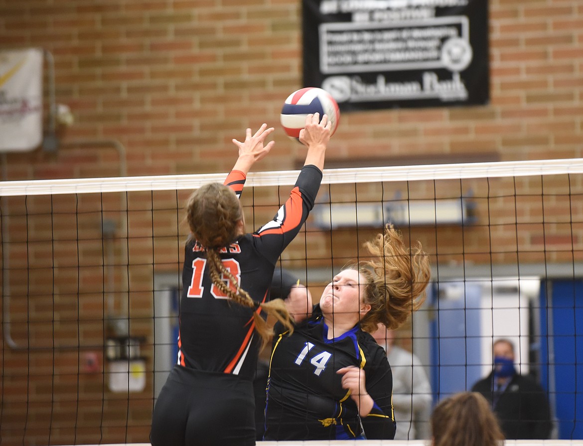 Thompson Falls' Abbi Lanes battles a Eureka player at the net during last Friday's District 7B championship. (Scott Shindledecker/Valley Press)