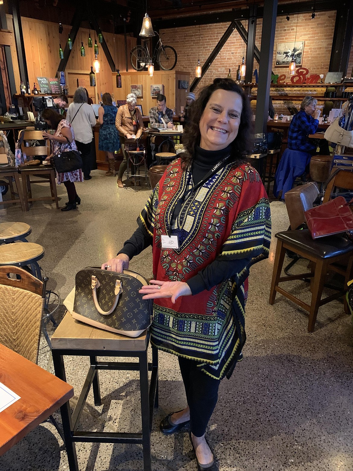 Kim Spencer models one of the purses available at North Idaho CASA's Purse Party fundraiser in 2019. This year's event will take place on Thursday, Nov. 19 from 4-7 p.m., Pend d’Oreille Winery.