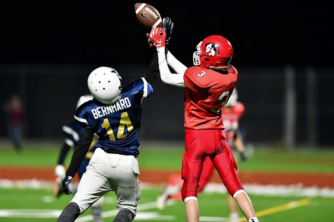 Brady Newhart goes up to catch a pass over a Timberlake defender during a game on Oct. 27 at War Memorial Field.