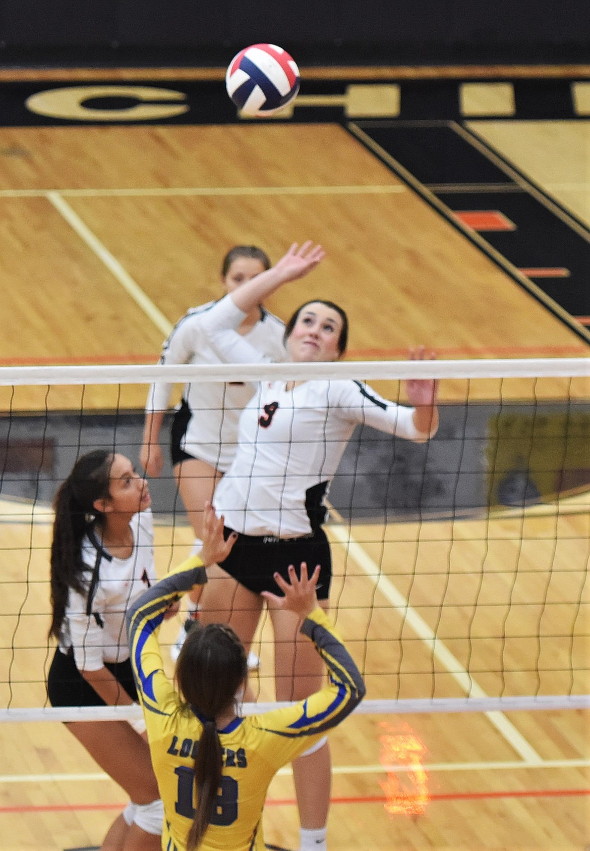 Senior Madeline McCrea prepares for a spike against Libby. (Scot Heisel/Lake County Leader)