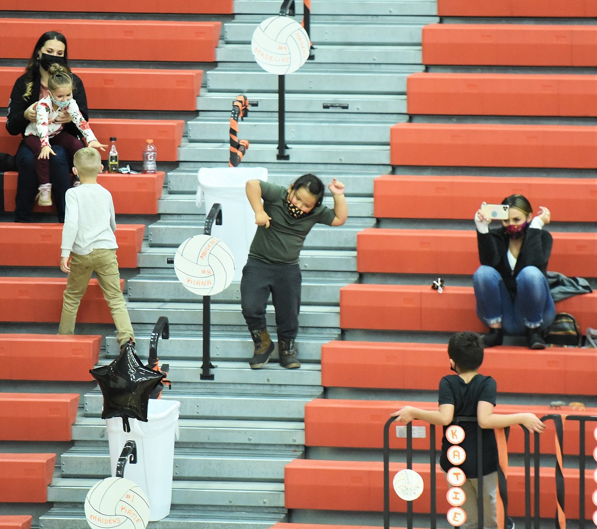 A young Maidens fan dances in the aisle during a break in the volleyball match between Ronan and Libby on Friday. (Scot Heisel/Lake County Leader)