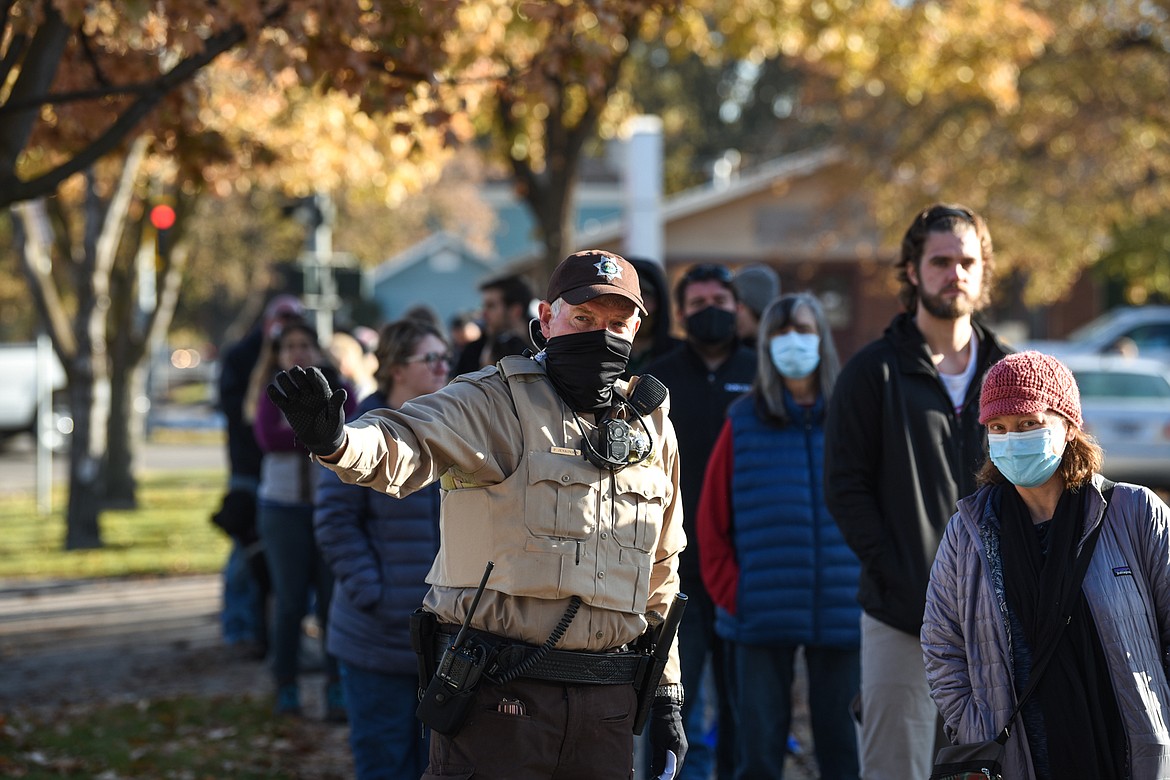 A member of the Flathead County Sheriff's Posse directs vehicle and pedestrian traffic and answers questions outside the Flathead County Election Department in Kalispell on Election Day, Tuesday, Nov. 3. (Casey Kreider/Daily Inter Lake)