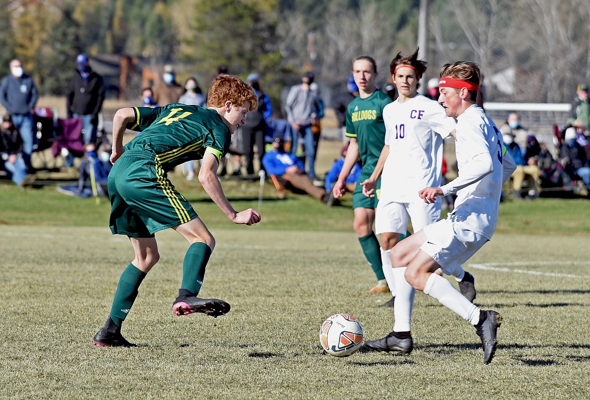 Bulldog senior defender Ian Grover (14) stops a Columbia Falls attack during the Class A final. (Whitney England/Whitefish Pilot)