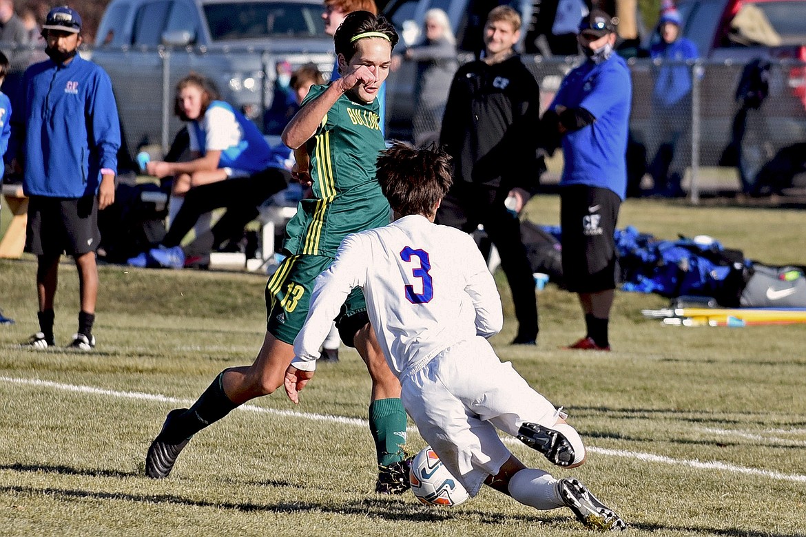 Whitefish senior co-captain Joshua Gunderson is challenged by Columbia Falls in the Class A boys soccer state final Saturday at Smith Fields. (Whitney England/Whitefish Pilot)