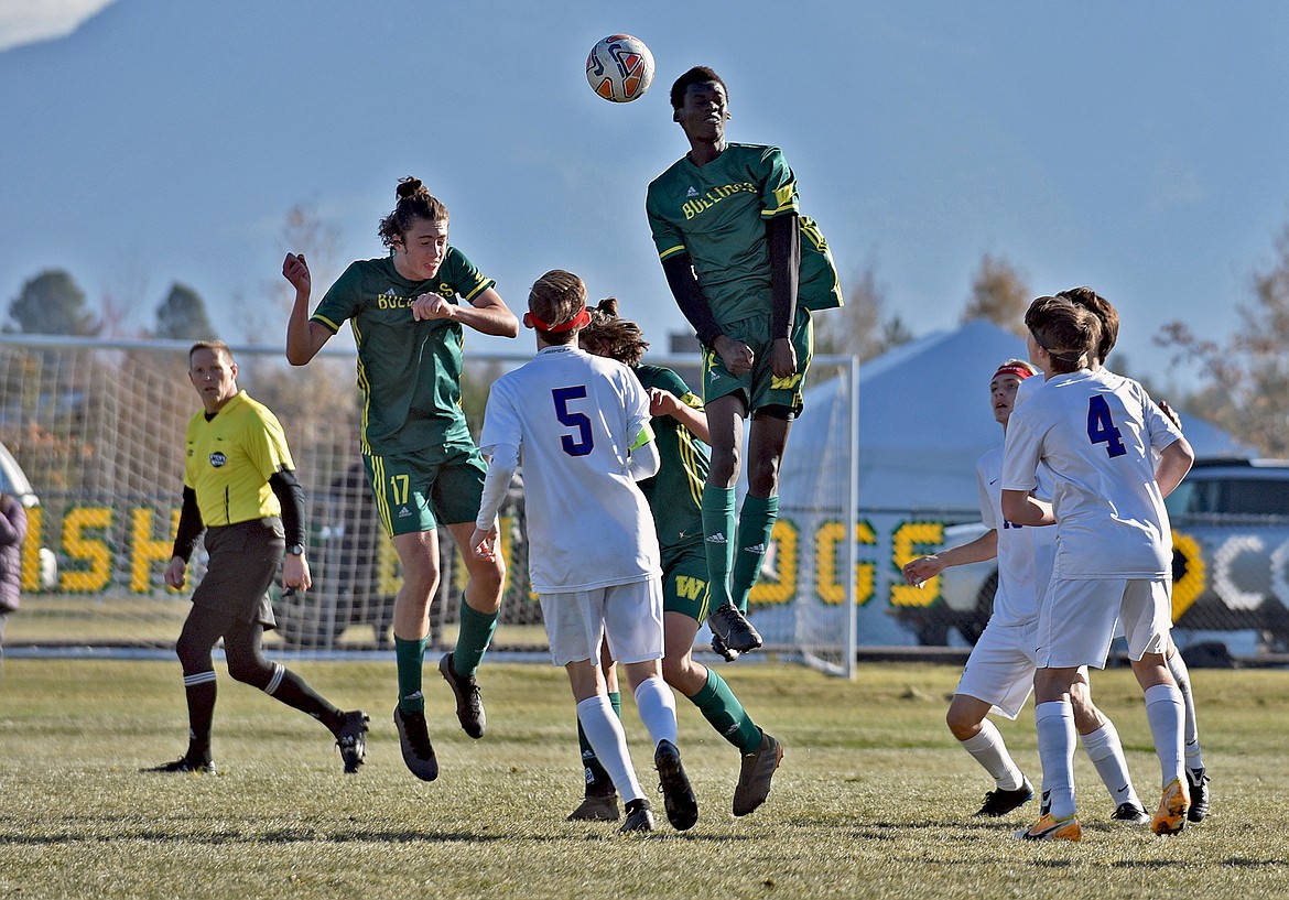 Whitefish's James Thompson (17) and Marvin Kimera (22) jump up for a header against CFalls in the Class A boys soccer state final Saturday at Smith Fields. (Whitney England/Whitefish Pilot)