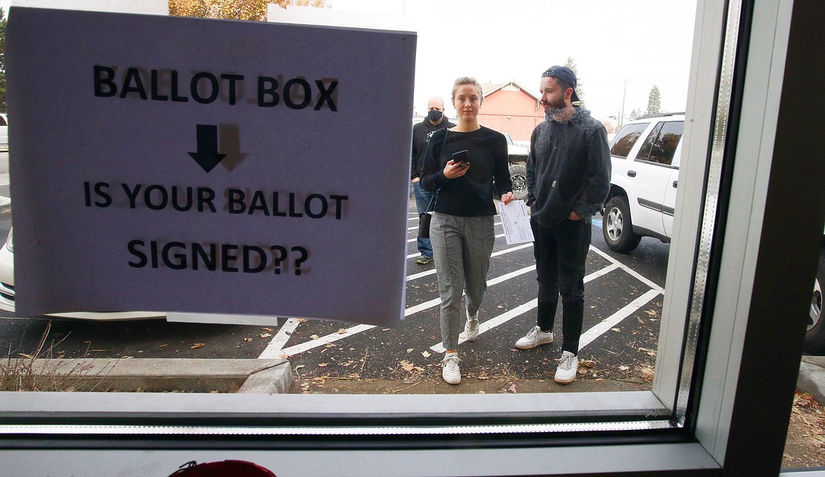 Residents arrive at the Kootenai County elections office on Third Street to drop off their ballots Tuesday.