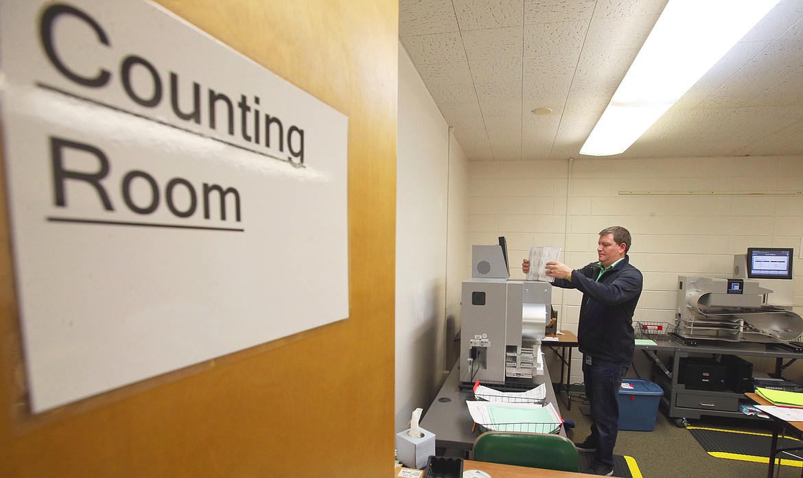 Trent Schlautman, project manager with ES&S Election Systems & Software, is at work Tuesday in the Kootenai County elections office.