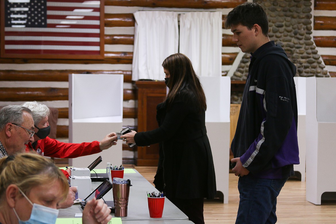 Poll workers help residents vote Tuesday evening at Sandpoint Community Hall.