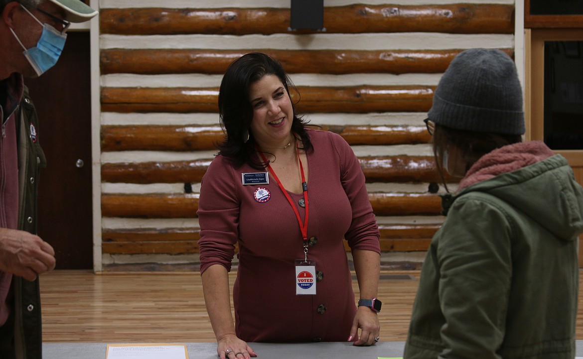 LisaMichelle Eigler, chief judge at the Sandpoint Community Hall locaiton, talks to voters Tuesday night.