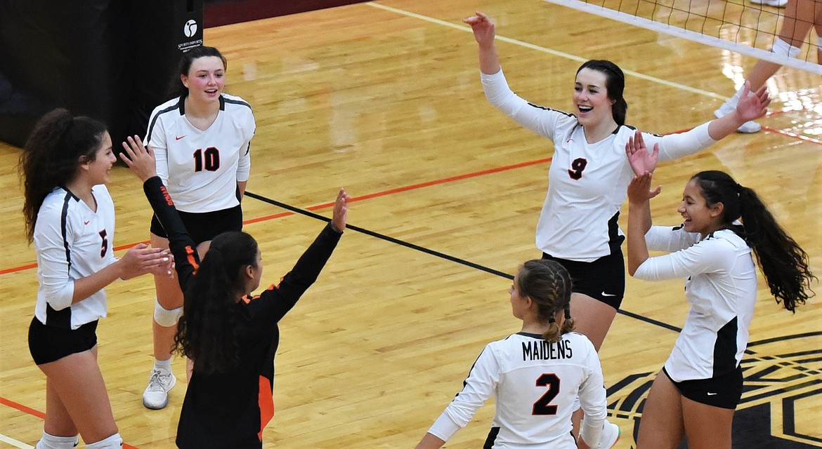 The Maidens celebrate after completing the sweep of Libby on Wednesday night. (Scot Heisel/Lake County Leader)