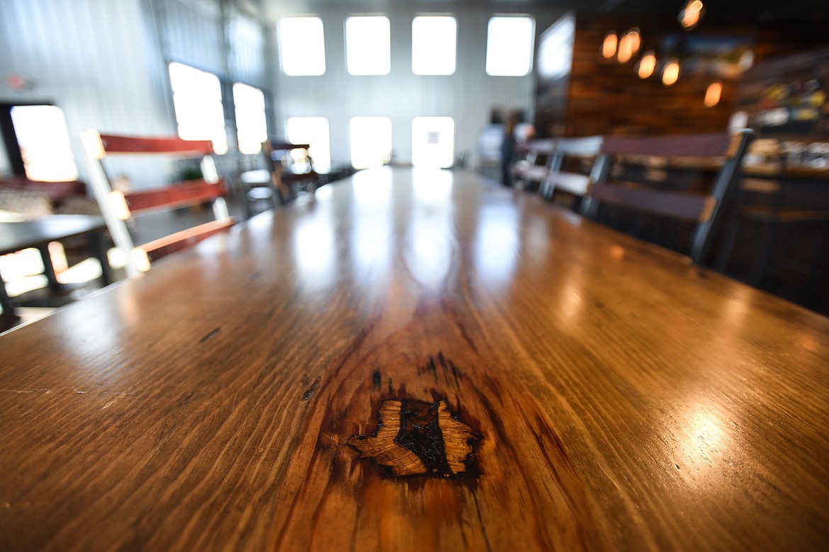 Detail of one of several long, wooden bar tables at Big Mountain Ciderworks on Tuesday, Nov. 3. (Casey Kreider/Daily Inter Lake)
