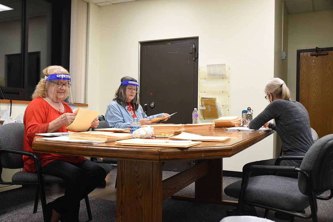 Election judges process votes at the Lincoln County Courthouse on Election Day. (Will Langhorne/The Western News)