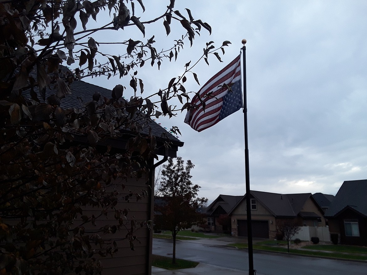 Storm clouds loom Friday afternoon as the American flag waves upside-down outside Chuck Brumbach's home. Brumbach said he was inspired to flip his flag around after seeing his neighbor do the same. The two Hayden homeowners are protesting the presidential election, in which former Vice President Joe Biden is leading in both the popular vote and the electoral college. (CRAIG NORTHRUP/Press)