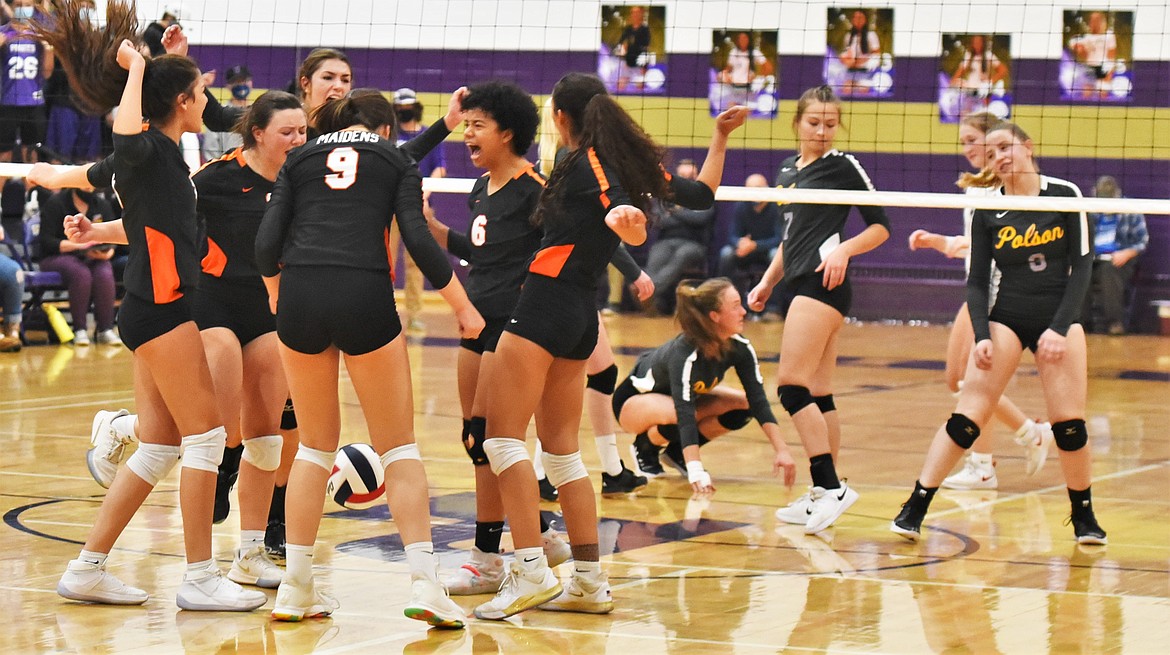 The Maidens celebrate after winning a point Friday night in Polson. (Scot Heisel/Lake County Leader)