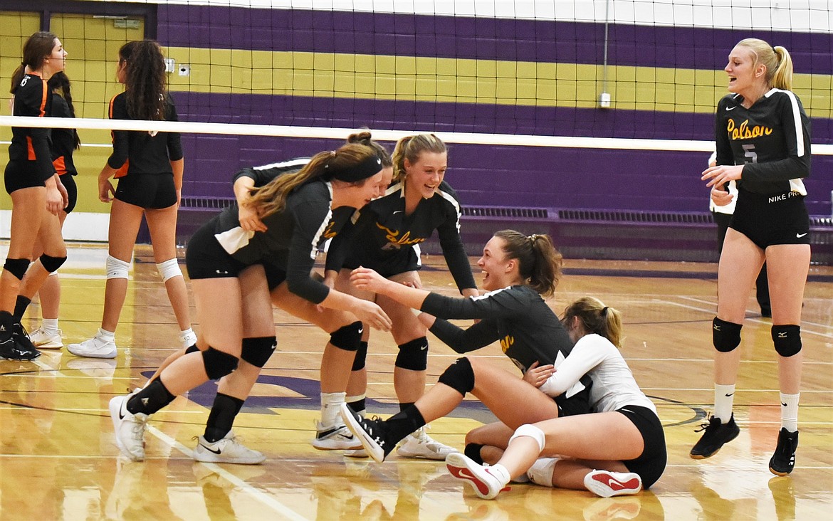 The Lady Pirates celebrate after clinching a trip to state with a four-set win over Ronan at home on Friday. (Scot Heisel/Lake County Leader)