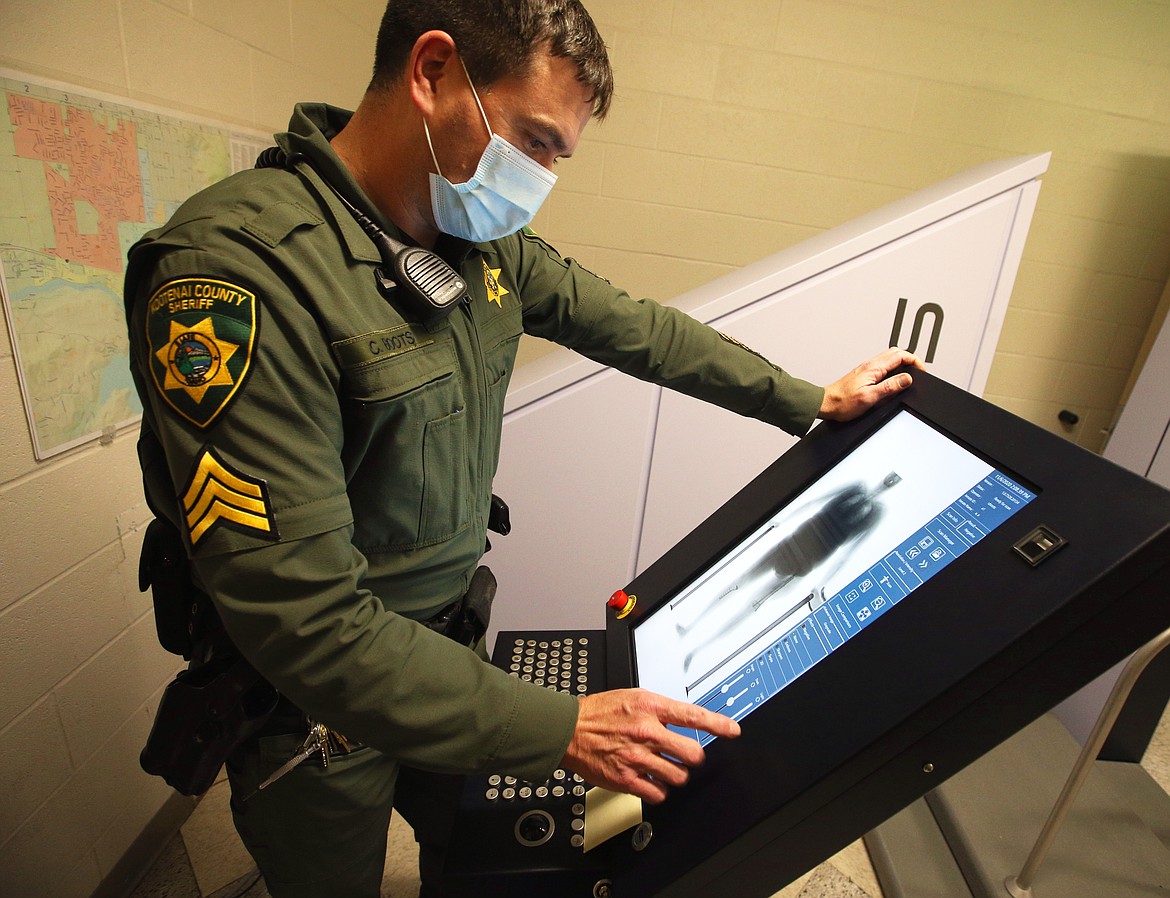 Kootenai County Sheriff's Sgt. Chris Boots operates the county's new full-body scanner at the jail on Friday.