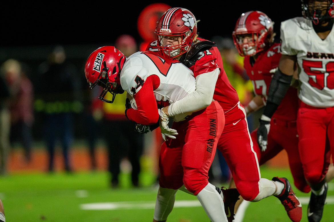 Junior Will Hurst tackles a Moscow player in the backfield during Friday's game at War Memorial Field.