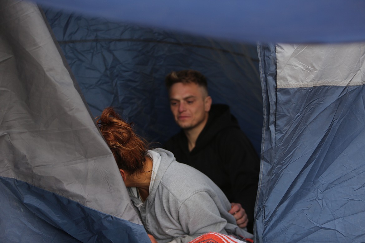Kurtis Larson and Feliz Espino were still huddled in their tent Monday afternoon trying to stay warm while temperatures briefly rose above freezing.