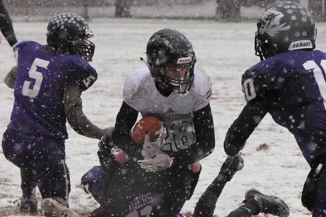 St. Regis defenders Luke Trogden (5) and Caleb Ball converge on a Horseshoe Bend player during Saturday's state playoff game. (Chuck Bandel/Mineral Independent)