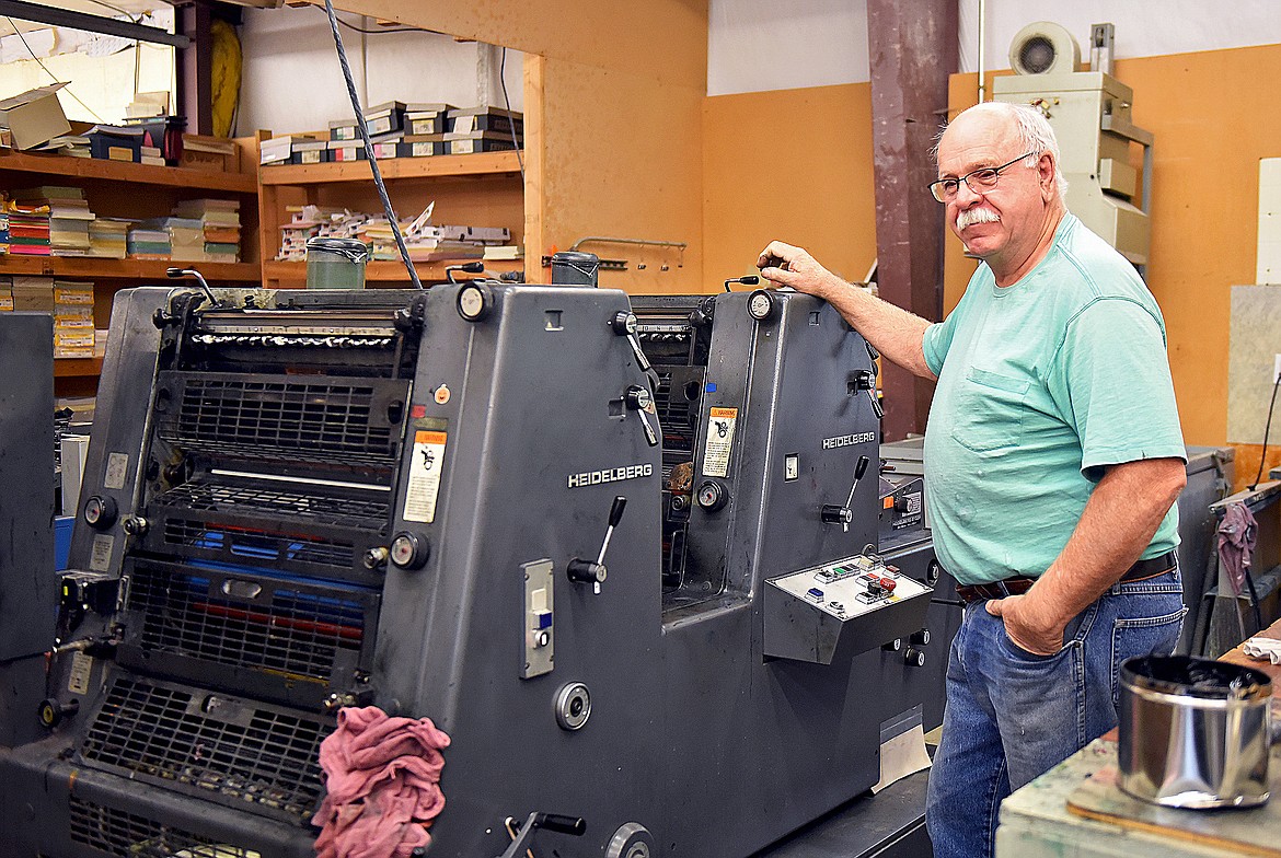 Top Copy's printing press operator Steve Schwartz tends to the machine as it prints out thousands of double-sided copies. Schwartz has been a press operator for 55 years, 20 of those years have been with Top Copy. (Whitney England/Whitefish Pilot)
