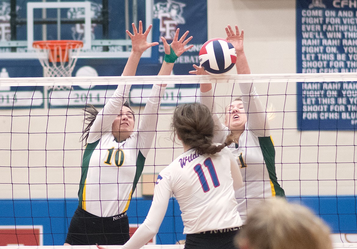 Bulldogs Jadi Walburn and Brook Smith go up for the block against the Wildkats last week in Columbia Falls. (Chris Peterson/Hungry Horse News)
