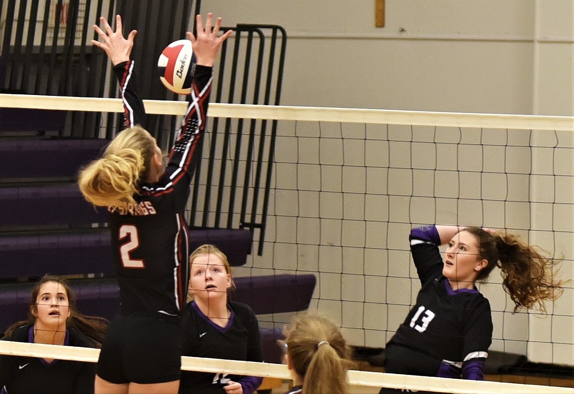 MollyKate Sullivan of Charlo hits one past Lily DeTienne of Hot Springs on Saturday. At left are Lady Vikings Mila Hawk and Connor Fryberger (12). (Scot Heisel/Lake County Leader)