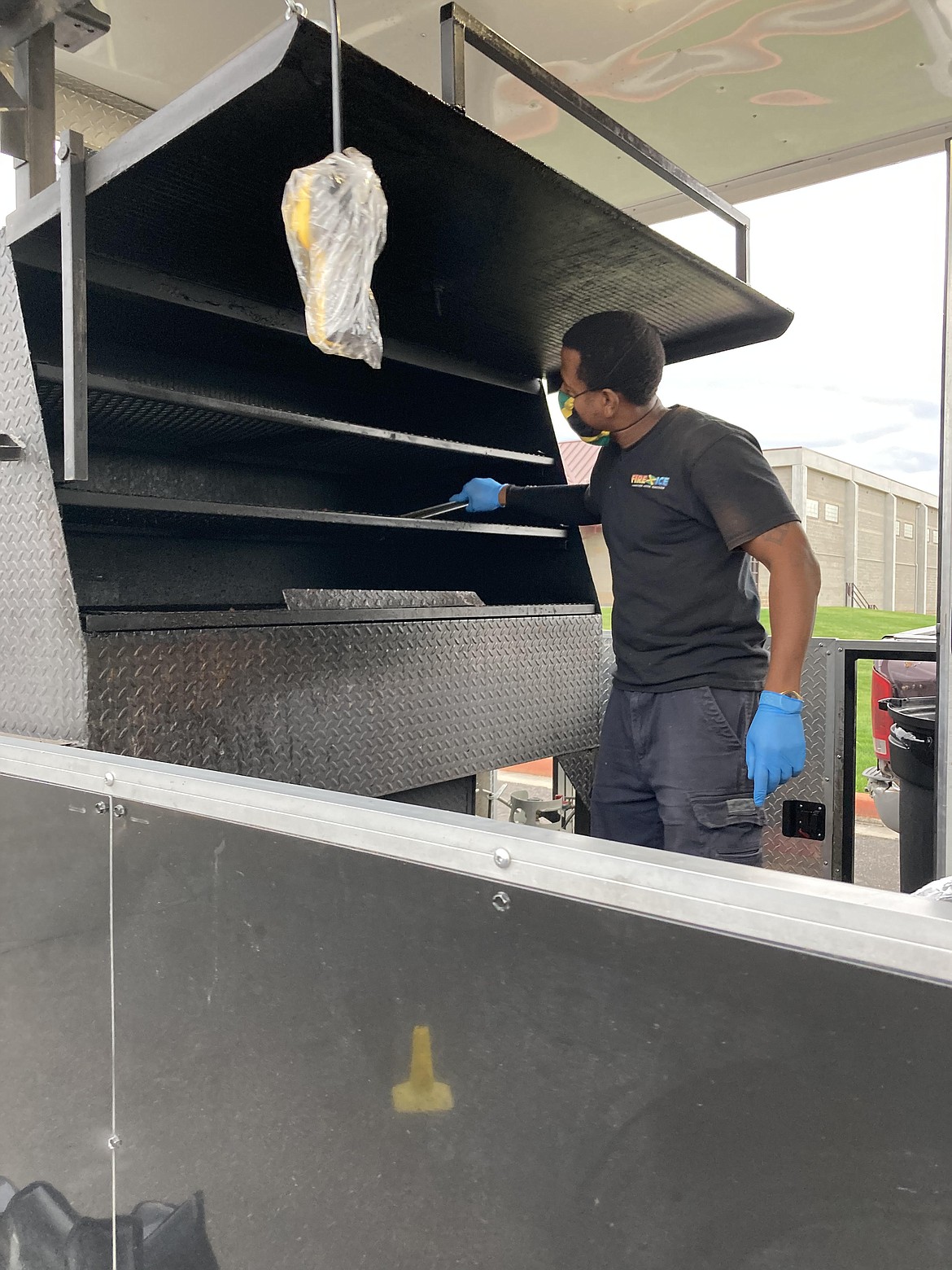 Terace Stewart grills his Jamaican jerk chicken on the back porch of the "Fire and Ice" food truck. (Carolyn Hidy/Lake County Leader)