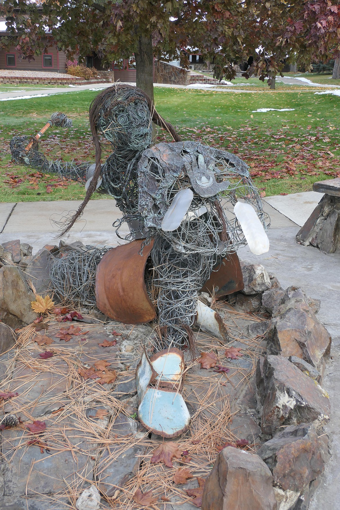 Dwight Billedeaux's "The Protector" watches over the Salish Kootenai College campus. The hand print was added to the shield to indicate the character successfully fought in hand-to-hand combat when a vandal failed to pull it off with a horse. (Carolyn Hidy/Lake County Leader)