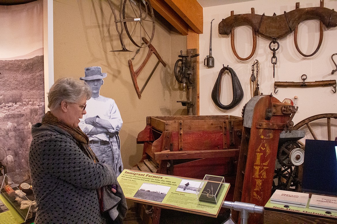 Quincy Museum & Historical Society Director of Operations Harriet Weber walks through the exhibits on display at the museum on Tuesday afternoon.
