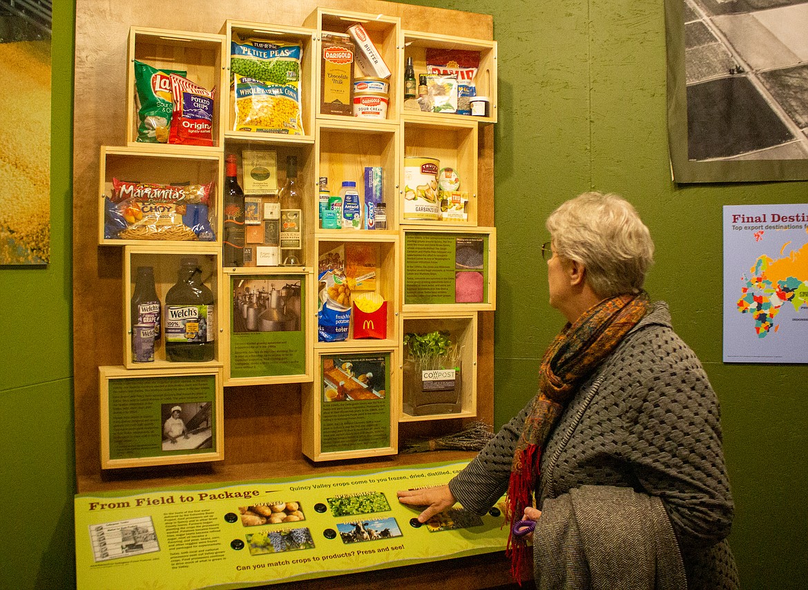Harriet Weber, Director of Operations with the Quincy Historical Society & Museum, shows off a display at the museum showcasing the various products produced with the agricultural products cultivated in the Quincy Valley.
