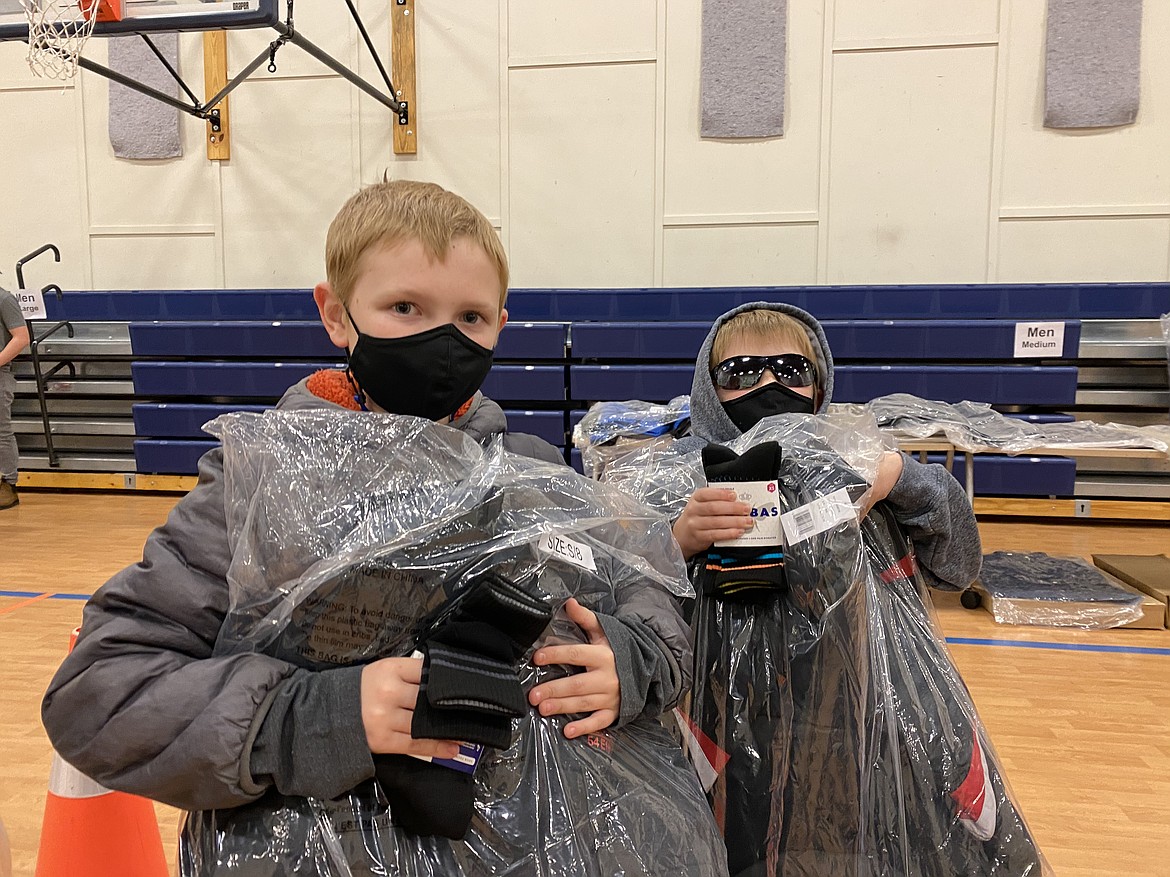 Zach, 10, and Koby Bollard, 7, are ready for winter in their comfy-cozy brand name jackets that they got Friday at the Lola and Duane Hagadone Boys & Girls Club coat giveaway. Zach, left, Koby, right. (MADISON HARDY/Press)