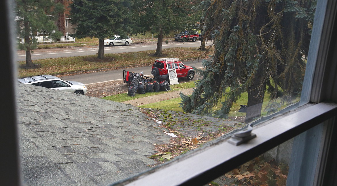 A view from the third-floor of the Hamilton House on Saturday finds a volunteer preparing to haul away leaves during the cleanup of the new home of the Music Conservatory of Coeur d'Alene.
