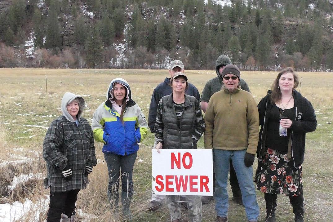 A group of Paradise sewage plant protesters stand in front of the field where the giant septic tank would be buried. (Chuck Bandel/Valley Press)