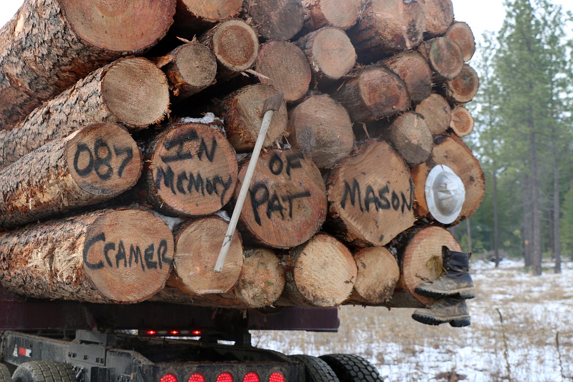 Kraig Watson's log truck features a tribute to longtime friend Pat Mason, who died in a logging accident on Nov. 5. In addition to a message painted on the logs, Watson tacked on his boots, axe and hard hat to honor his friend. The truck was one of several dozen which took part in a parade through the region where Mason lived and worked.