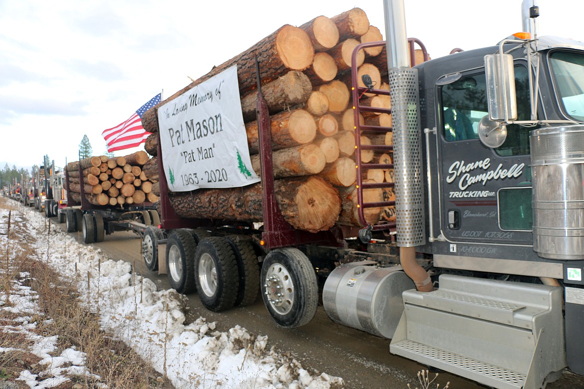 A tribute to Pat Mason adorns the side of a logging truck taking part in Saturday's parade in honor of the longtime logger.