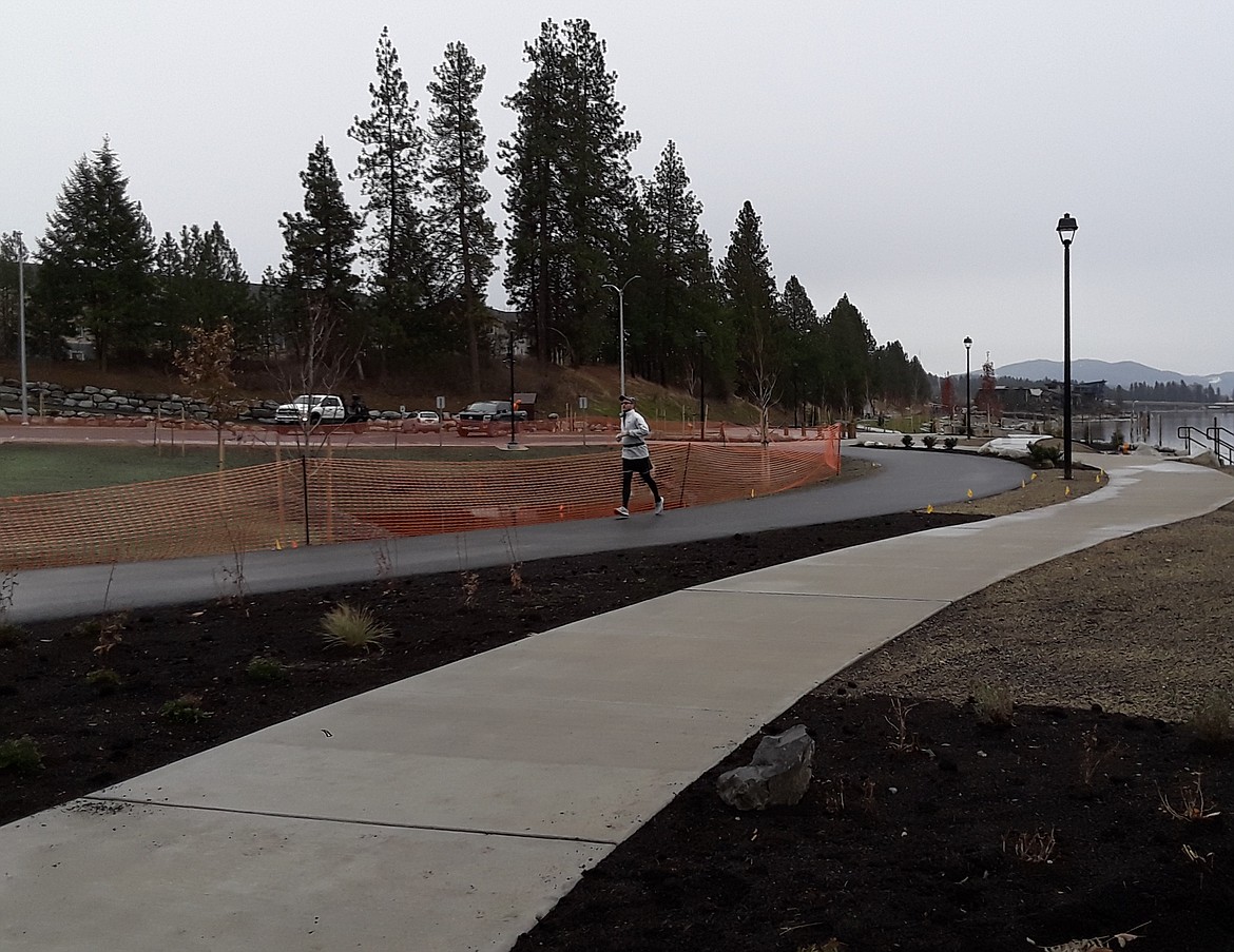 A jogger enjoys the Atlas Mill Park Monday, the newest addition to Coeur d'Alene's park system.