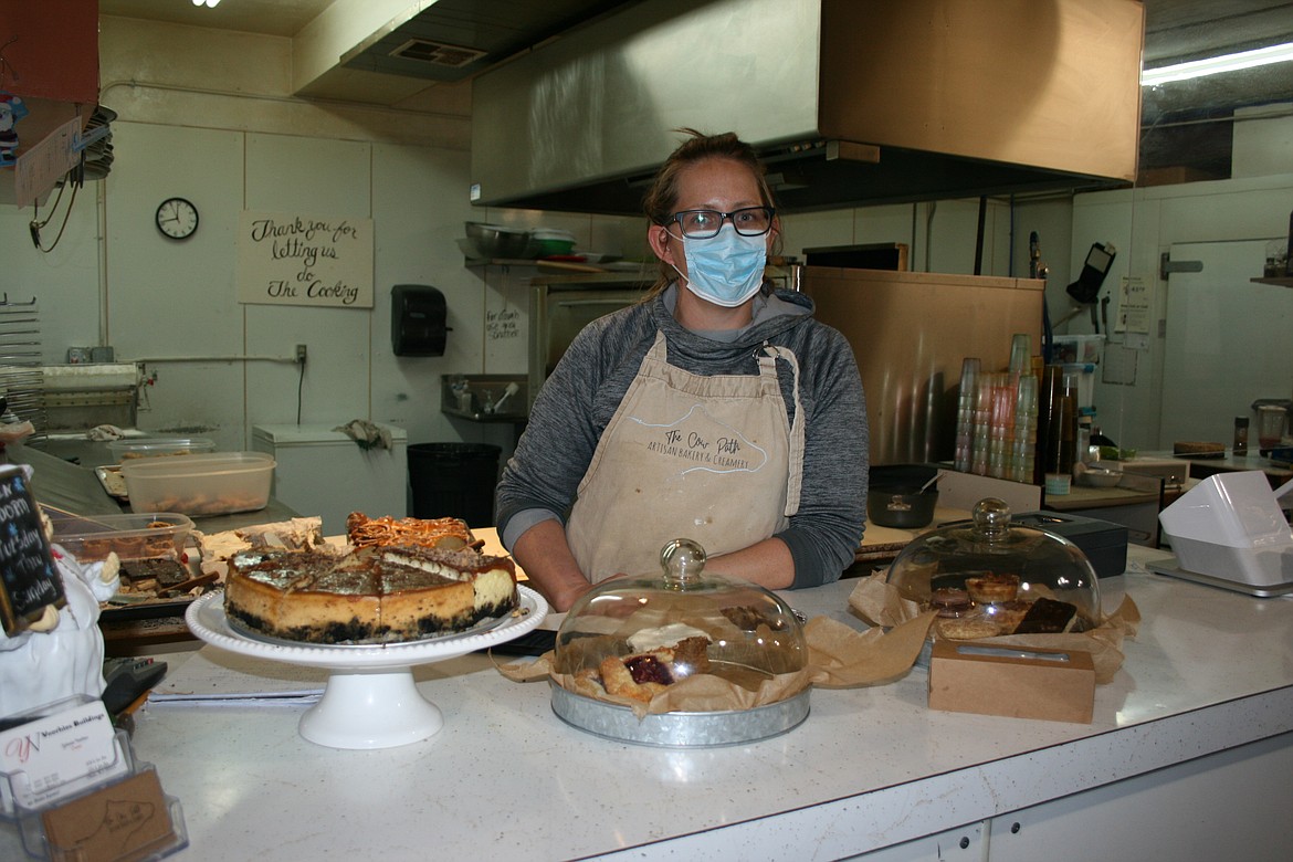 The Cow Path Artistic Bakery and Creamery owner Janice Baginski shows off some of the selections at the bakery's pop-up sale, using the kitchen at the Pizza Factory.