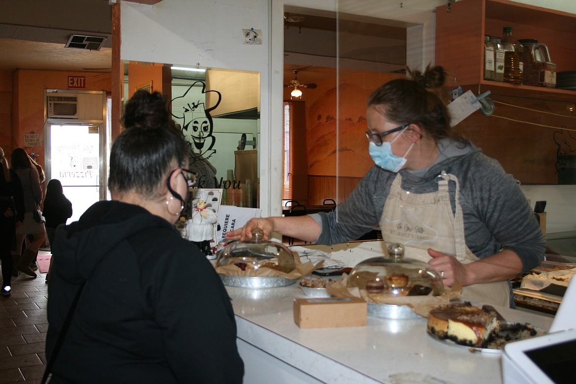 Cow Path Artisan Bakery and Creamery owner Janice Baginski (right) helps customer Sandy Lopez (left) make her selections.
