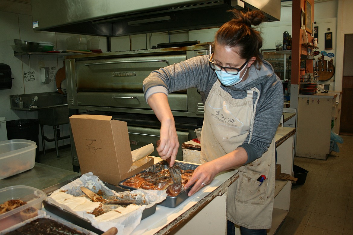 Janice Baginski fills a customer's box during the pop-up bakery sale put on by her shop, Cow Path Artisan Bakery and Creamery.