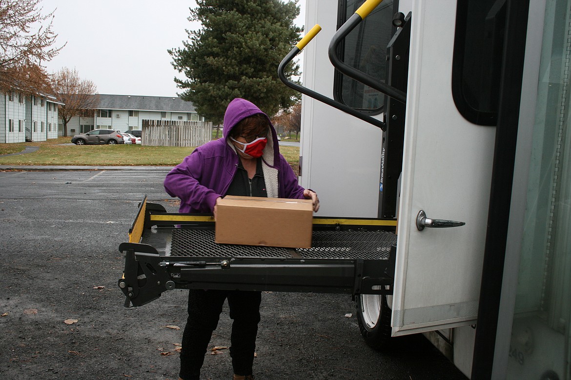 Sharon Mobley loads food into the People for People bus for transport to Hatton for distribution to food bank clients. The delivery is the result a new partnership between the food bank and People for People.