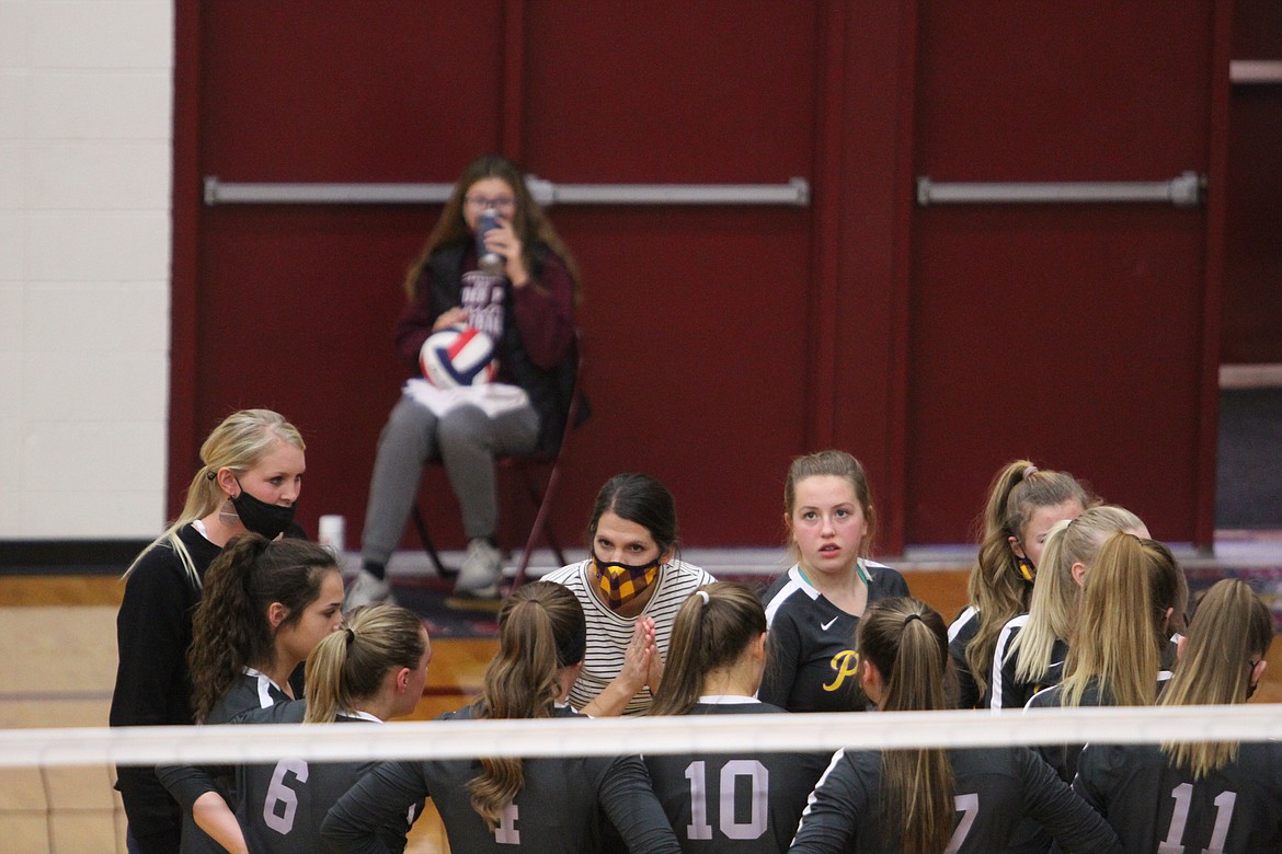 Polson head coach Lizzy Cox (center, yellow mask) addresses her team during the Lady Pirates' match with Ronan on Saturday in Sidney. (Dillan Schorfheide/Sidney Herald)