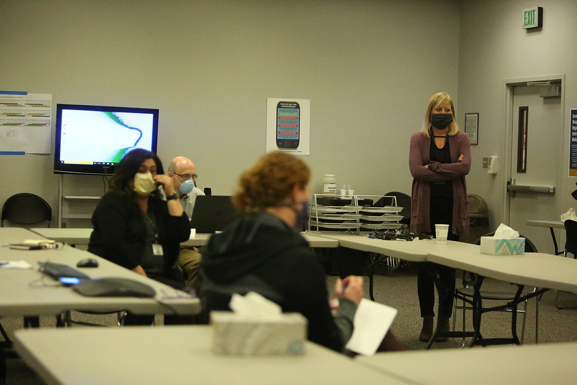 Grant County Health District Administrator Theresa Adkinson, right, meets with other health district staff and contact tracers during an April meeting, shortly after the pandemic began. A little over seven months later, the health district is no longer able to keep up with contact tracing amid a surge in cases.