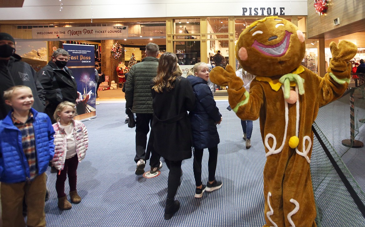 Parks and Seeley Vandewerker visit with a colorful character at The Resort Plaza Shops Tuesday before the boat cruise to the North Pole.