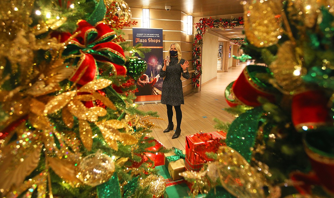 Amy VanSickle, director of marketing at The Coeur d'Alene Resort, chats with guests in the resort lobby before Tuesday's night boat cruise to the North Pole.